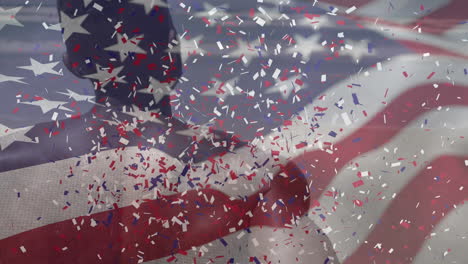 animation of american flag waving confetti falling over african american man on beach