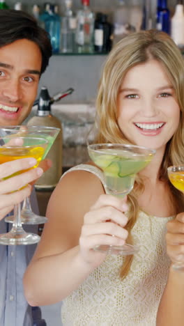 group of friends toasting glasses of cocktail