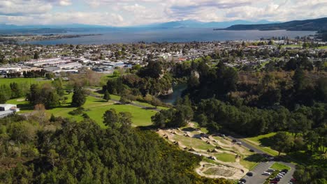Scenery-of-Lake-Taupo-and-Taupo-town,-aerial-over-mountain-bike-park