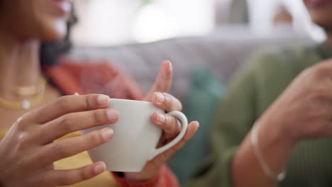 couple, coffee cup and women hands on sofa in home