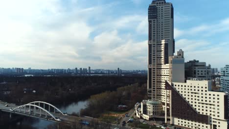 aerial view of a city with a tall building, river, and bridge