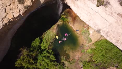 Drone-Shot-showing-a-waterfall-in-the-red-rock-of-Southern-Utah