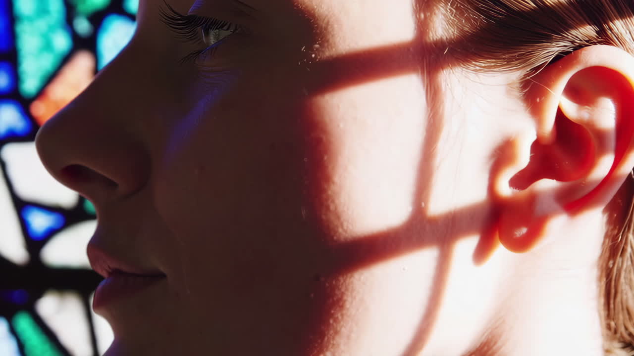 Woman's face near stained glass window
