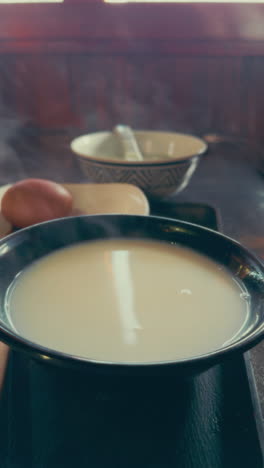 person eating japanese rice porridge