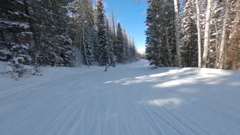 fearless snowboarder rides down terrain in the stunning slopes of aspen