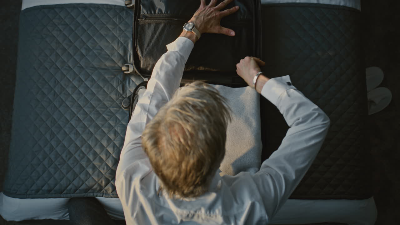 Packing a suitcase on a bed