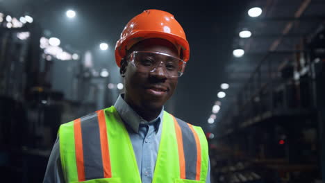 Cheerful-engineer-smiling-camera-at-manufacturing-production-factory-closeup