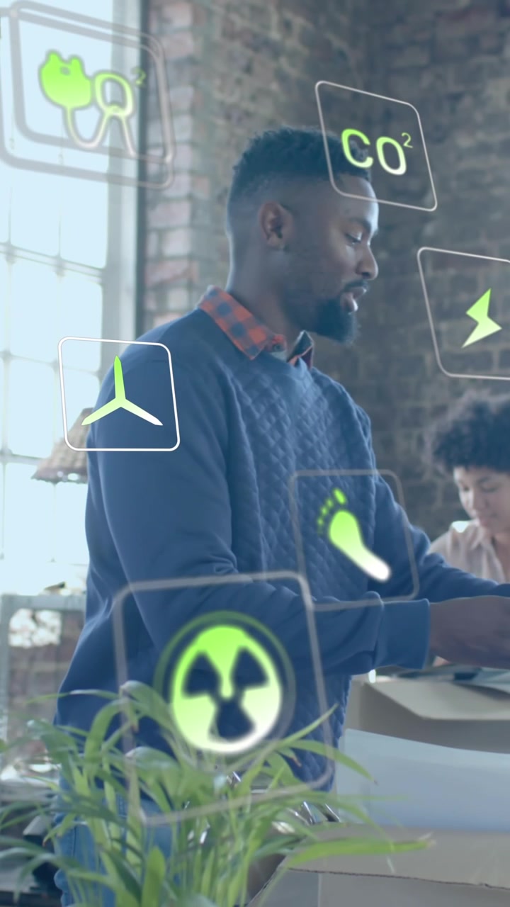 Animation of ecology icons over diverse colleagues working in office