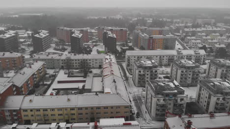 roofs of residential buildings with snow on a foggy winter day in trollhattan, sweden