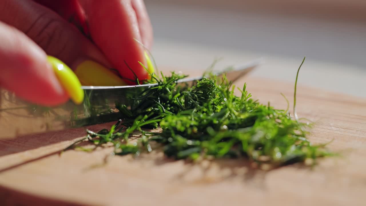 Macro view of person slicing dill herbs symbolizing food security and care