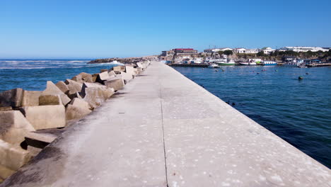 new harbour pier with reinforced concrete dolosse on one side, drone dolly