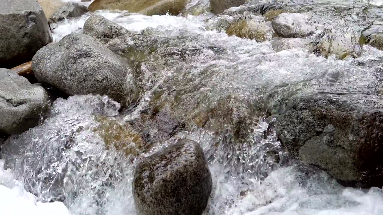 L'acqua scende a cascata sulle rocce in questa splendida scena autunnale di montagna