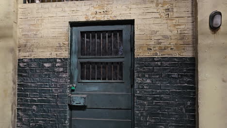 walking towards locked door of old korean prison cell at iksan film drama set