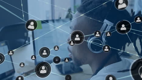 Animation-of-network-of-connections-with-icons-over-african-american-businessman