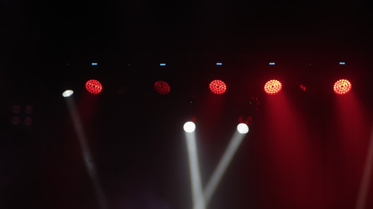 Dynamic Stage Lights with Red and White Beams in Smoke