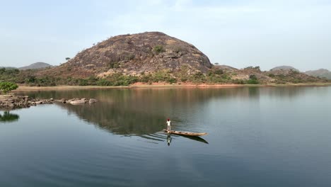 aerial - dolly wide shot of a fisherman on a lake