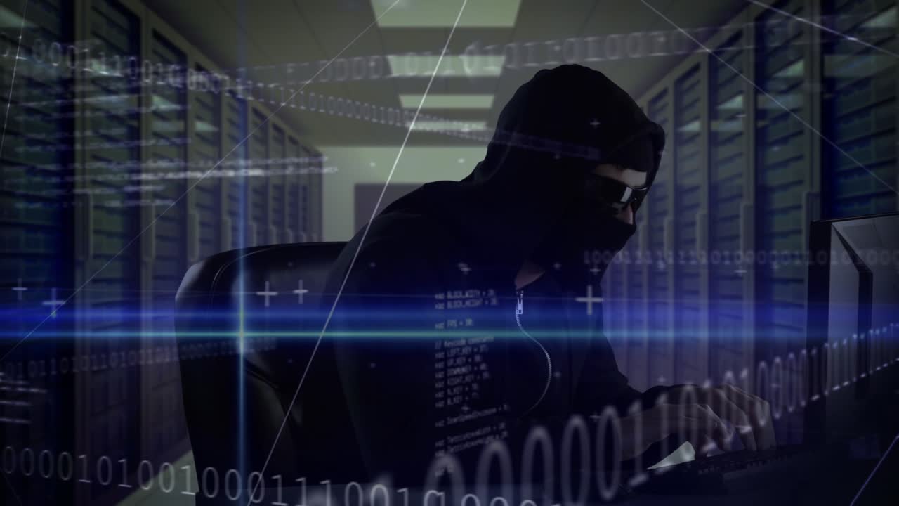 Animation of binary coding processing over caucasian male computer hacker in balaclava using laptop