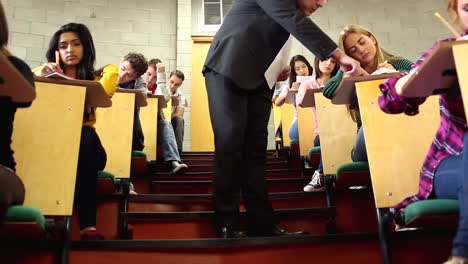 lecturer supervising a test in lecture hall