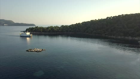 Aerial-shot-over-a-sea-ferry-on-Lopud-island-in-Croatia,-during-sunset