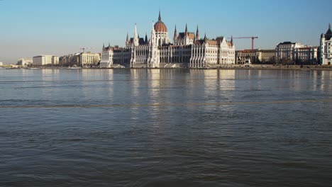 Budapest-city-center-view-with-Parliament-building-and-Danube-river-on-a-sunny-day,-gothic-architecture,-wide-low-angle-panoramic-shot