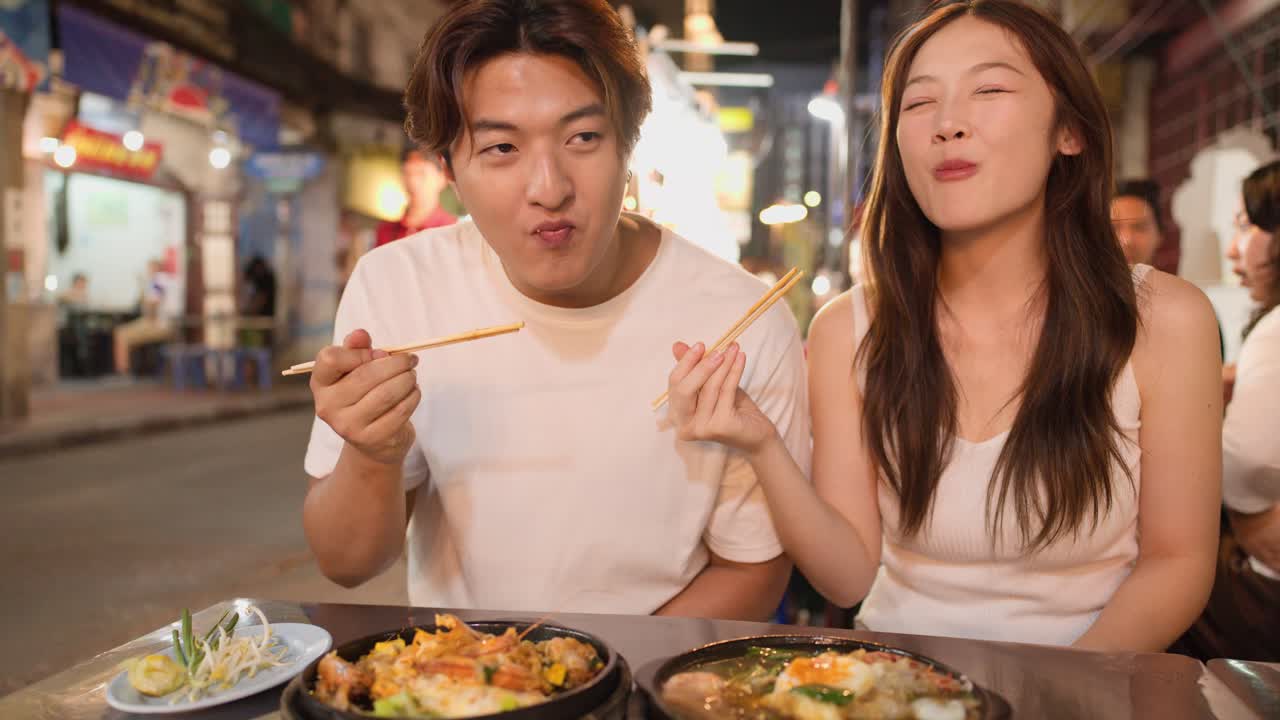 Couple Enjoying Street Food at a Night Market