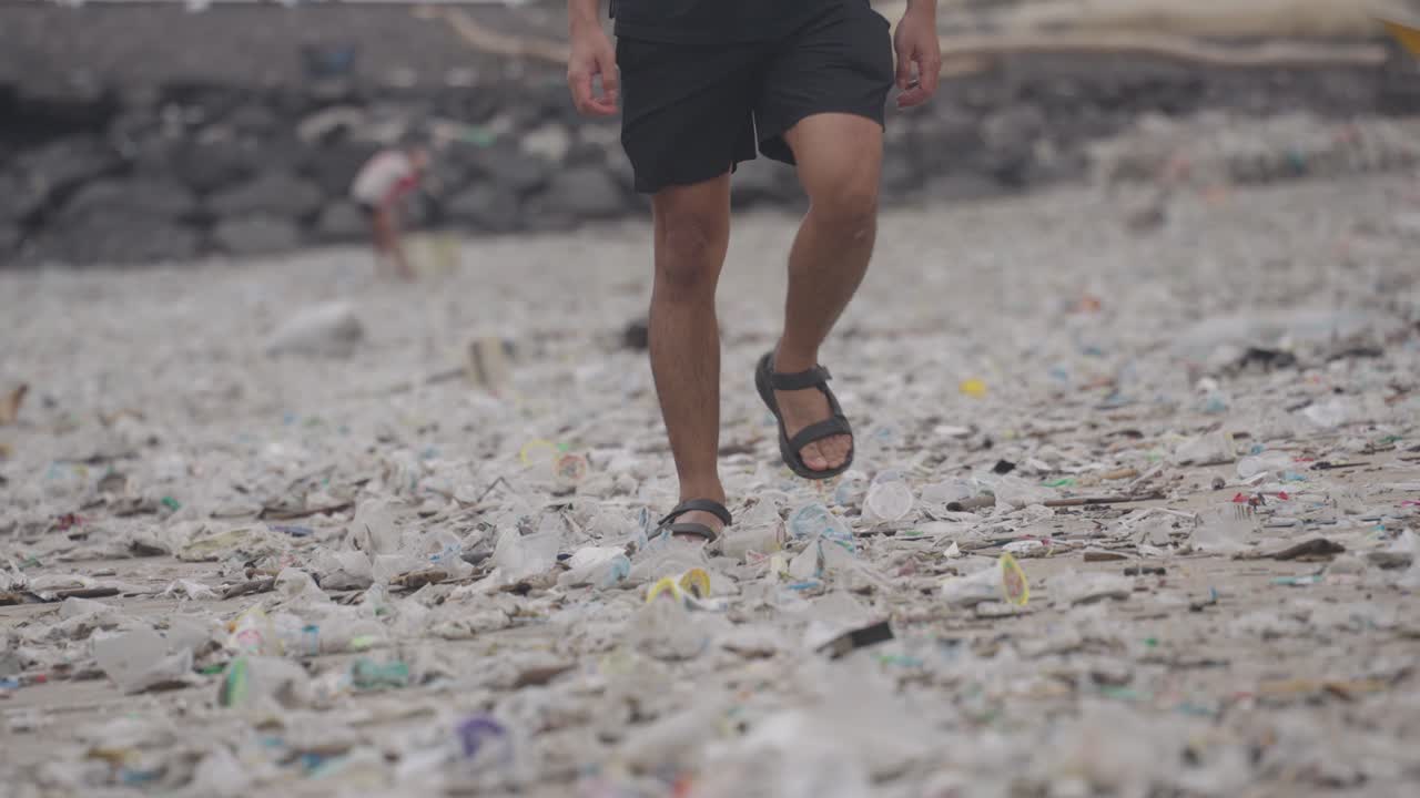 Person walking on a polluted beach