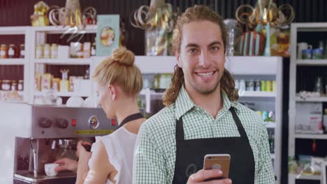 animation of letters moving over caucasian man using cellphone and woman making coffee in cafe