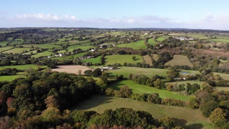 aerial shot with a view of a village and the beautiful east devon countryside in england