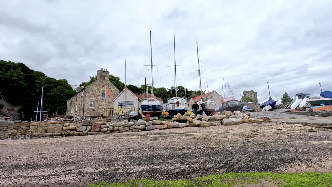 Boats docked near a stone pier