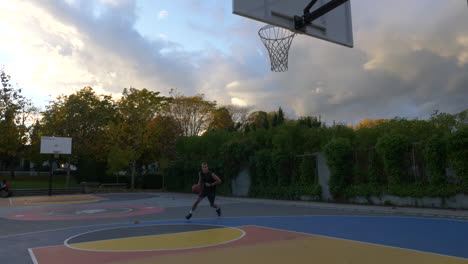 Young-basketball-players-dribble-and-shooting-into-the-net-by-layup-during-a-practice-session