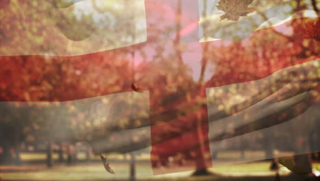 digital composition of england waving flag over multiple autumn leaves falling against park