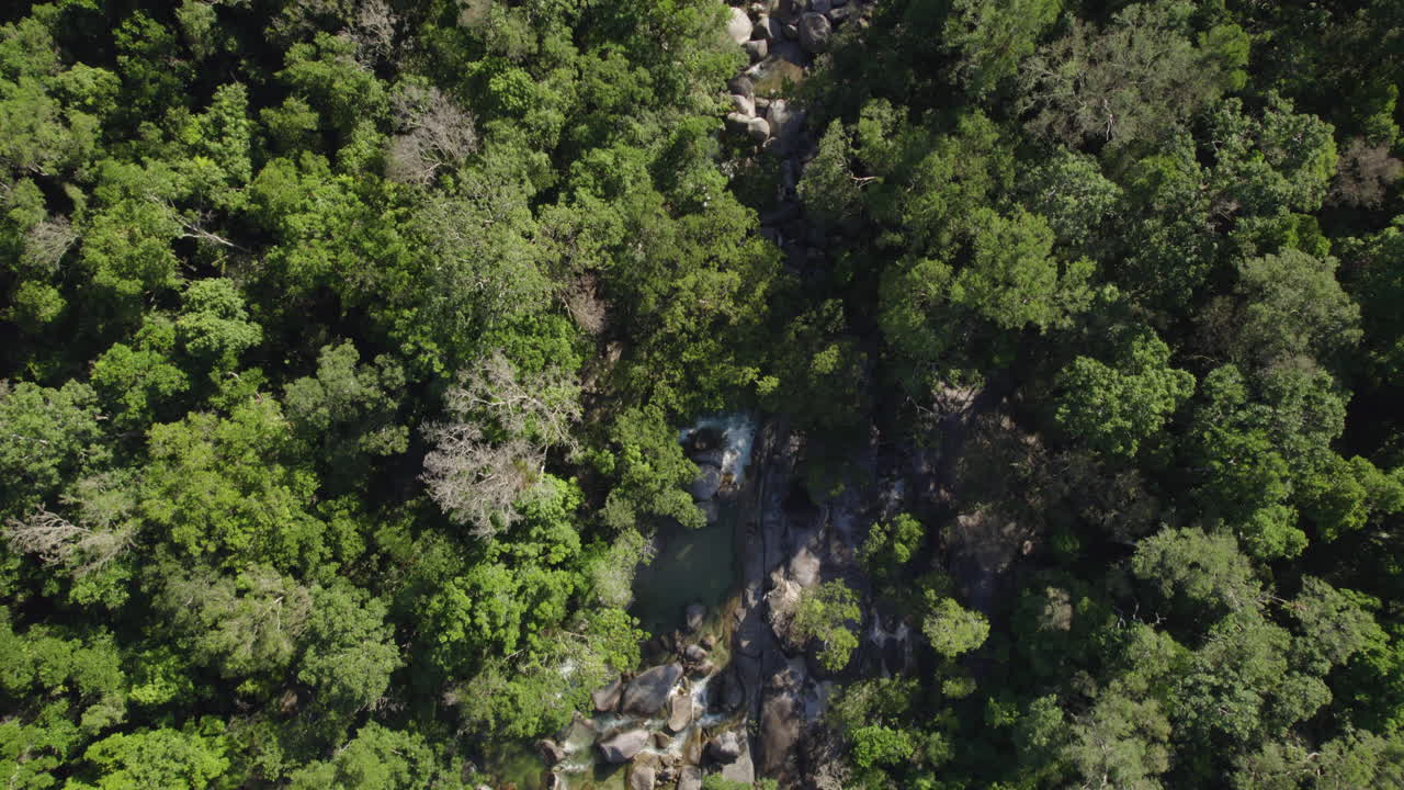 Drone flying along the rocky Jinkalmu River, in Daintree Rainforest, Australia