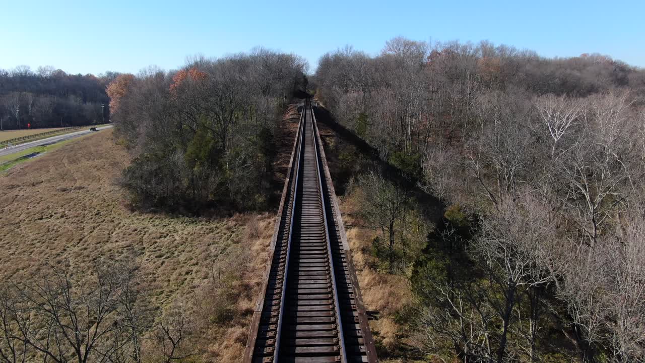 Aerial Shot Pushing Forwards Along the Pope Lick Trestle Railroad Tracks on a Sunny Afternoon in Louisville Kentucky