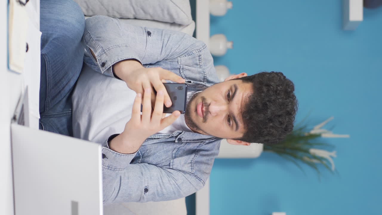 Vertical video of Man getting breakup texting gets upset.