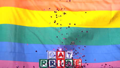 Rainbow-flag-moving-in-the-breeze-with-gay-pride-blocks-and-confetti-falling