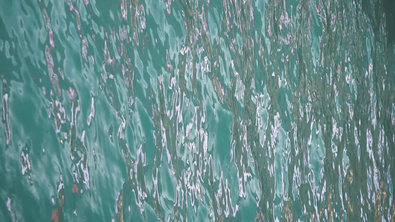 Rippling Turquoise Water Surface with Light Reflections