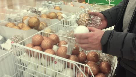 man shopping for christmas ornaments in a store