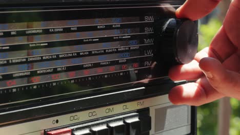old retro am fm radio with tubes, hand changing stations , bulb vintage music player.