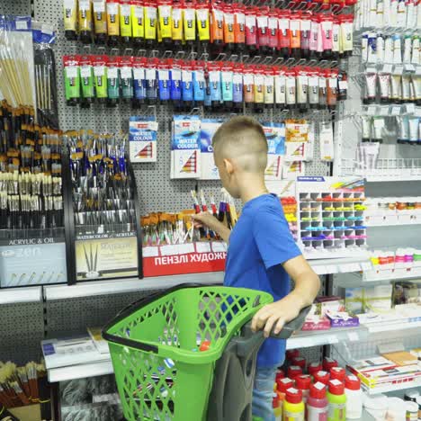 vinnitsa, ukraine - august 20, 2018: back to school. boy choosing school stationery at the supermarket.