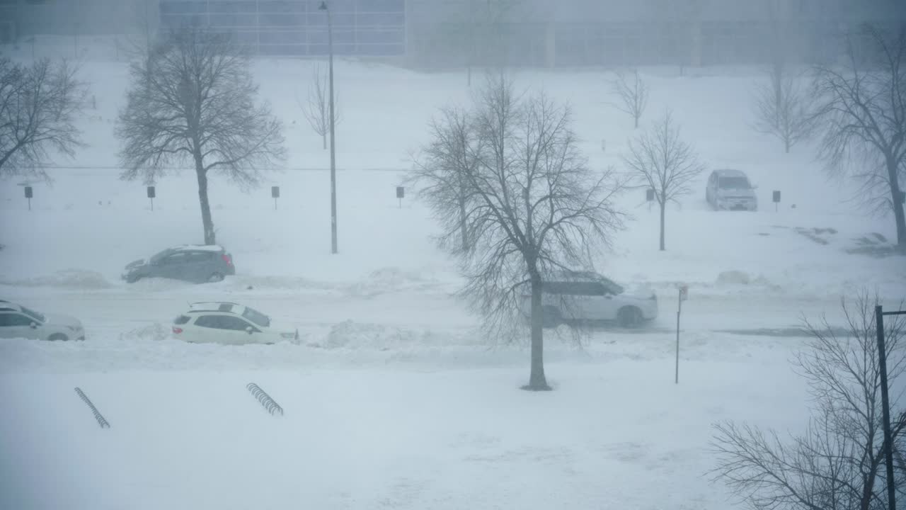 White SUV drives by in heavy snow storm