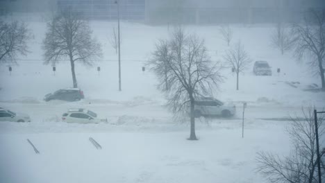 white suv drives by in heavy snow storm