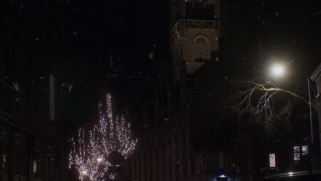 Winter-snowfall-in-the-night-in-Europe-Netherlands-Holland-Dutch-city-town-with-lights-and-traditional-architecture-houses-buildings