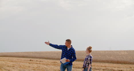 Female-Farmer-Discussing-With-Businessman-On-Farm-8