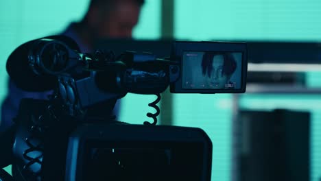 close up detail video of the camera filming recording the face of a suspect offender perpetrator or close up detail video of the camera filming recording the face of a suspect offender perpetrator or prisoner talking to a detective policeman on the background true crime documentary creative