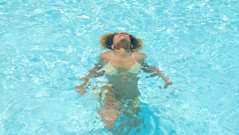 Girl-With-Afro-Haircut-Relaxing-in-Swimming-Pool