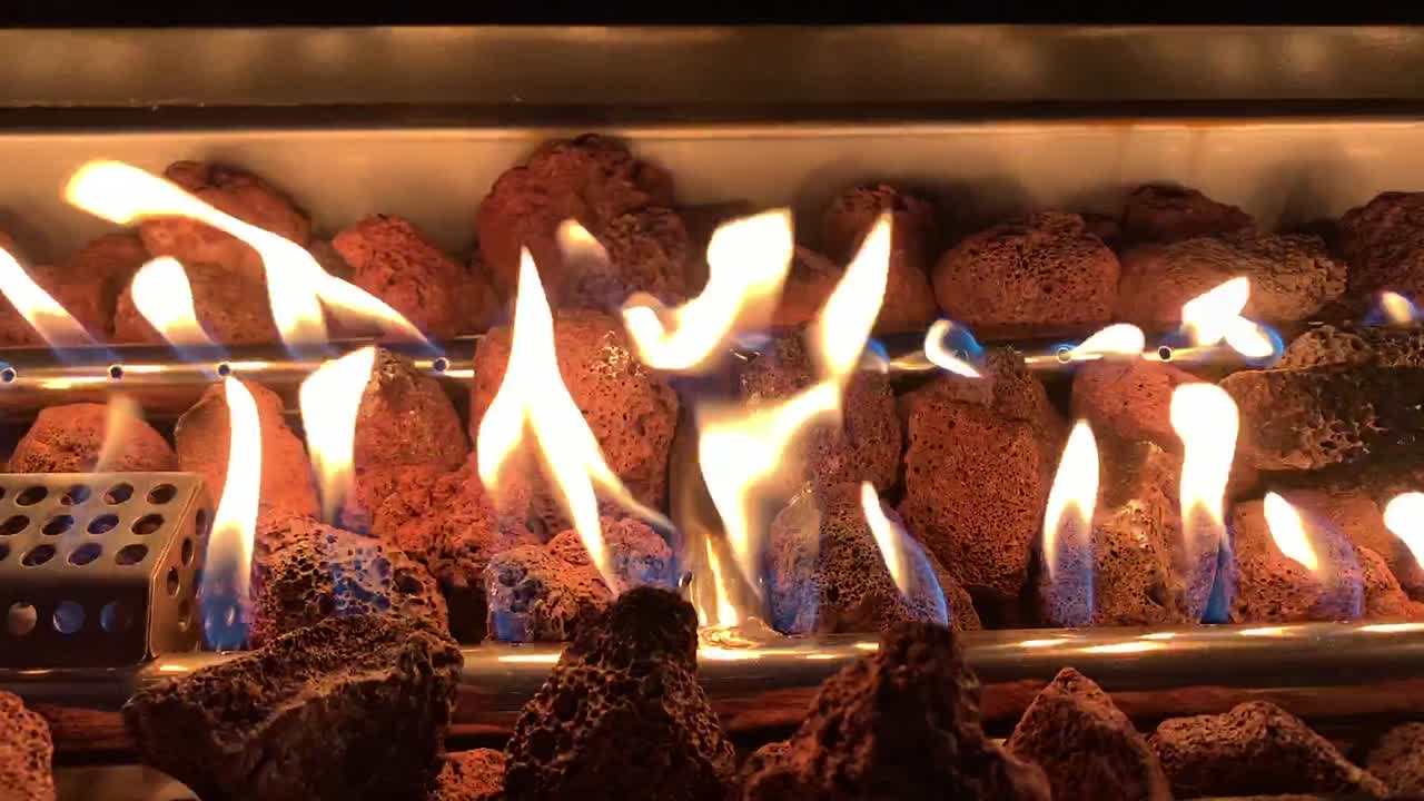 Close-Up View of a Gas Fire Pit with Lava Rocks