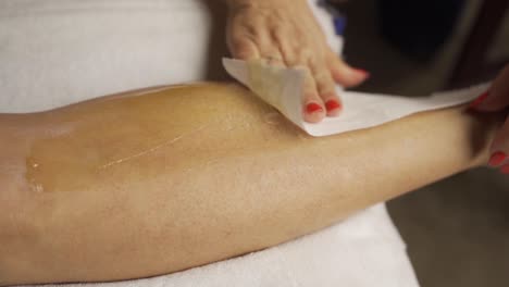 depilation with wax on female legs slow motion close up
