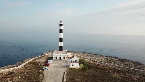 Flying-Towards-Artrutx-Lighthouse-In-Menorca,-Spain---aerial-drone-shot