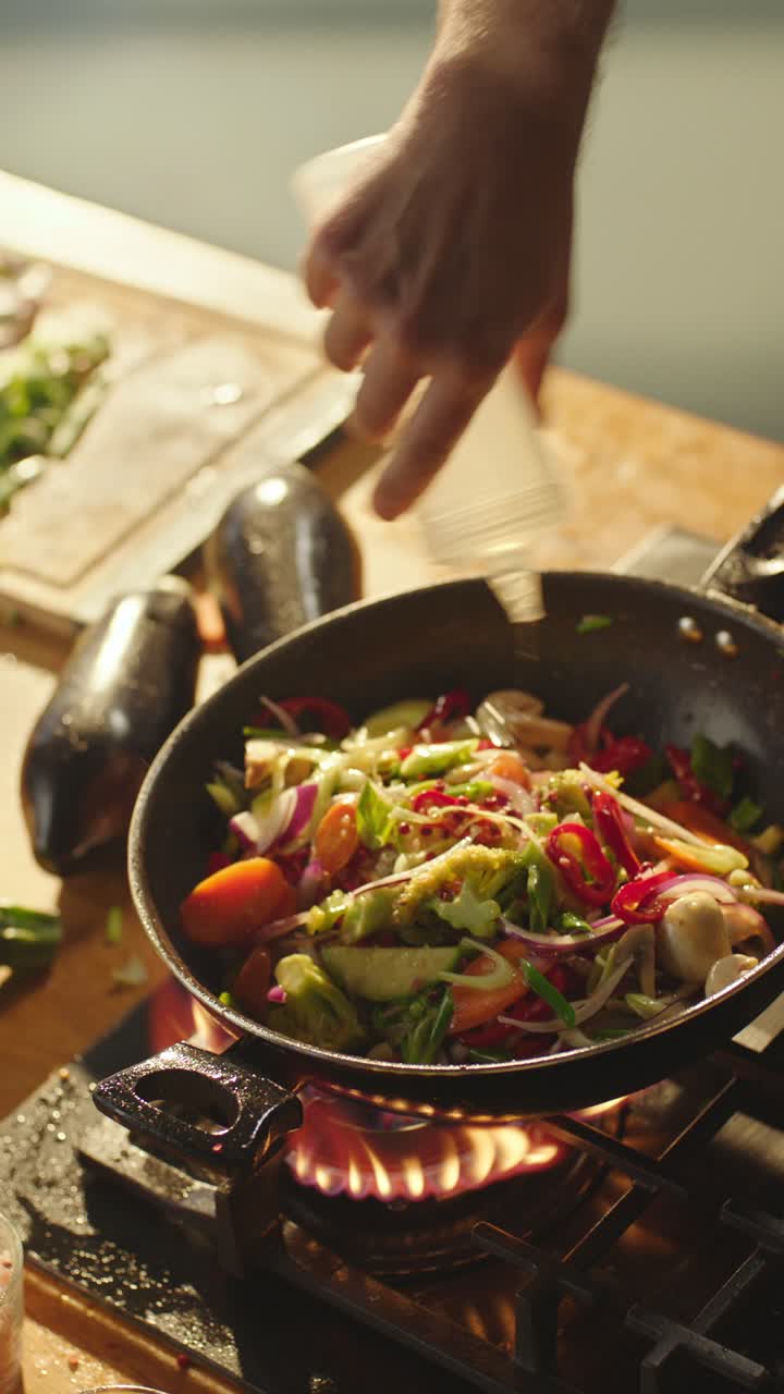 Preparing vegetable stir fry on a gas stove