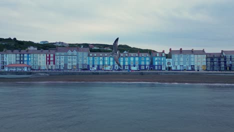 drone footage on a summer day in uk wales aberystwyth around the beach, harbour, sea side, clif and town front-22